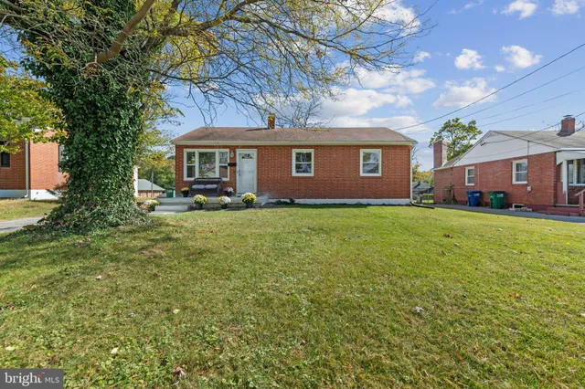 a large house with a big yard and large trees