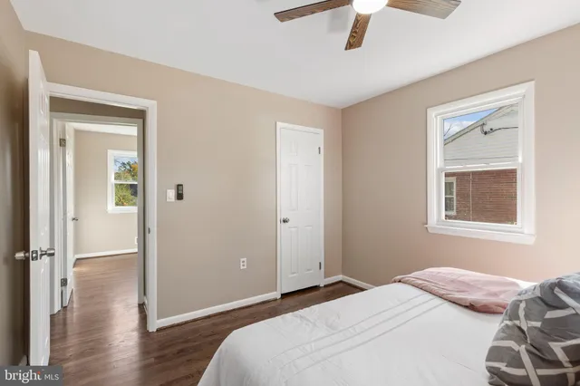 a bedroom with a bed and a chandelier fan