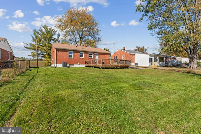 a front view of house with yard and trees