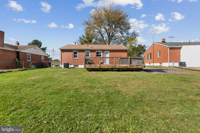 a view of a house with a big yard and large trees
