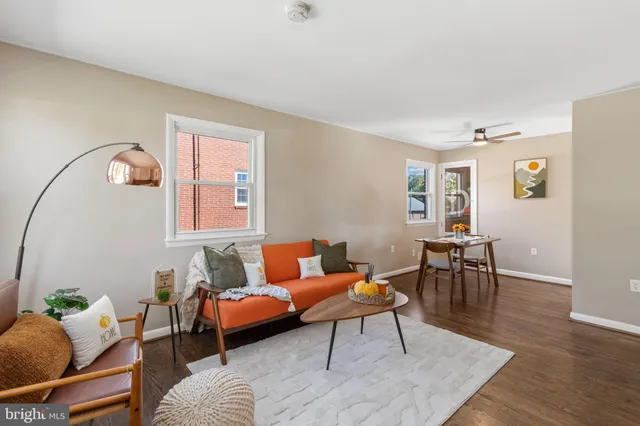 a living room with furniture and wooden floor