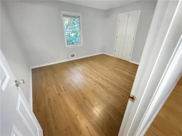 a view of room with window and hardwood floor