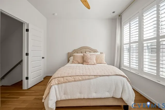 a spacious bedroom with a bed and a large window