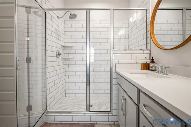 a living room with furniture a potted plant and a large window
