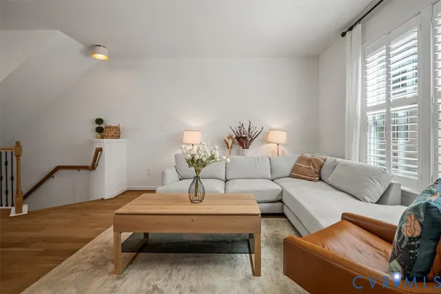 a living room with furniture and wooden floor