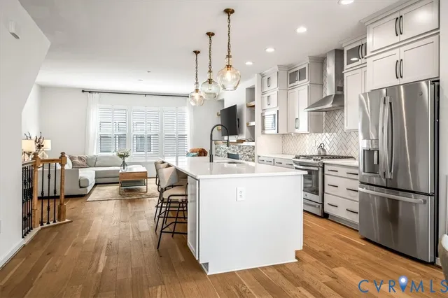 a kitchen with stainless steel appliances granite countertop a stove and a microwave
