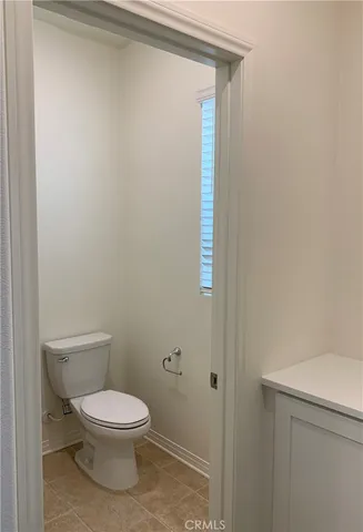 a white toilet sitting next to a bathroom sink