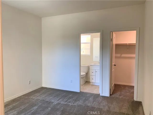 a view of a room with an empty space and wooden floor