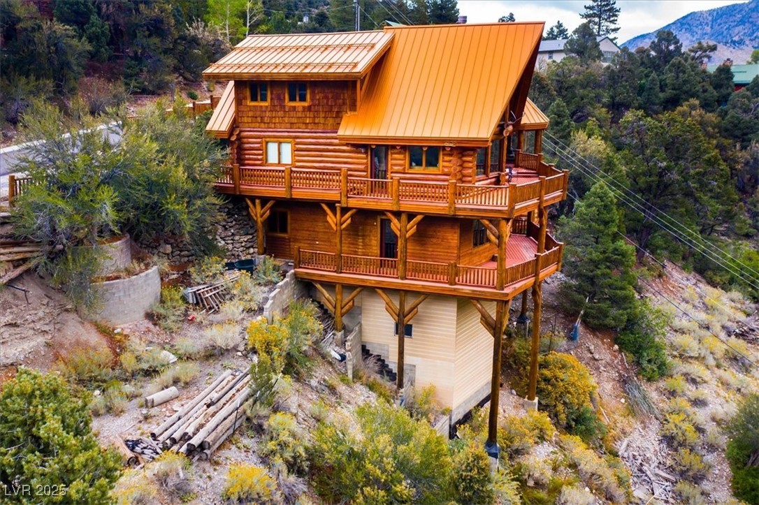 4925 Spruce Road Las Vegas, NV 89124 - Photo 32 of 49 Back of property featuring a wooden deck and a metal roof