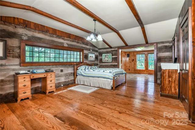 a bedroom with furniture and a large window