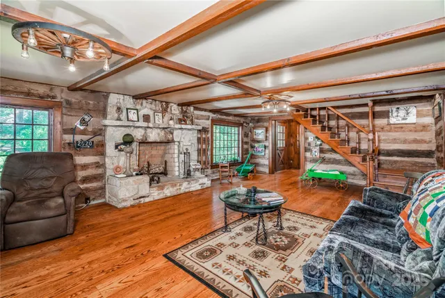 a living room with patio furniture and a wooden floor