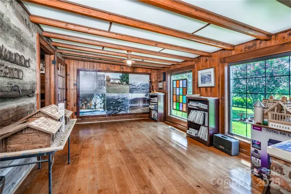 a room with wooden floor and furniture