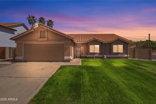 a front view of a house with a garden and deck