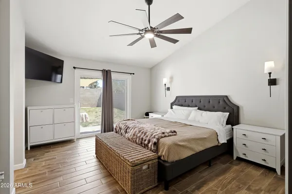 a bedroom with a large bed and a window