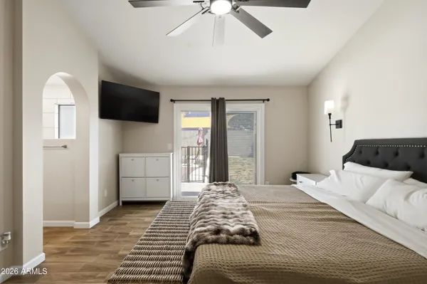 a bedroom with a large bed and a tv