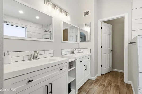 a spacious bathroom with a double vanity sink double and mirror