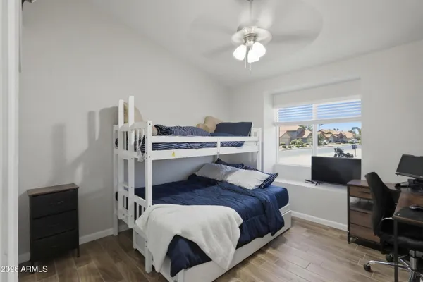 a bedroom with a bed and a chandelier