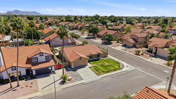 an aerial view of a houses with a city street