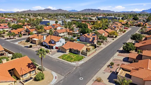 an aerial view of residential houses with outdoor space