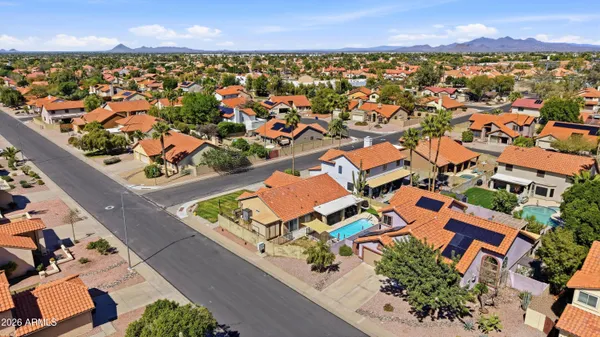 an aerial view of residential houses with outdoor space