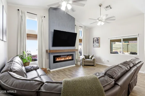 a living room with furniture a fireplace and a flat screen tv