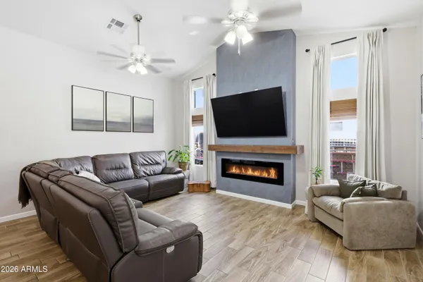 a living room with furniture a fireplace and a flat screen tv