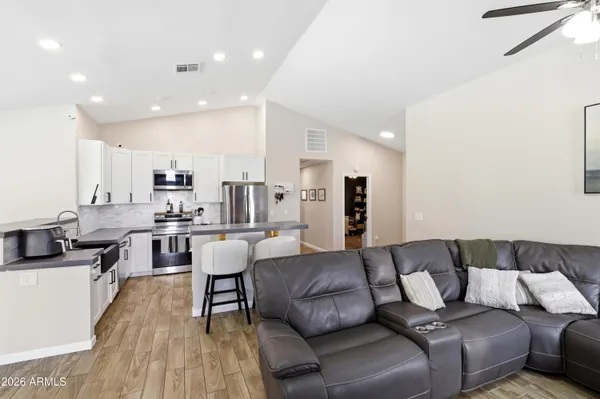 a living room with furniture and a wooden floor