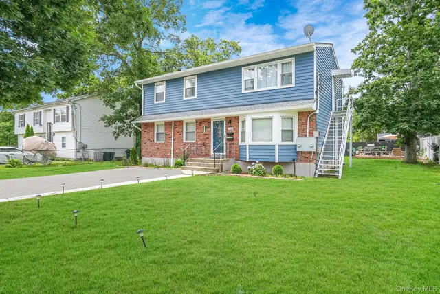 a front view of a house with garden