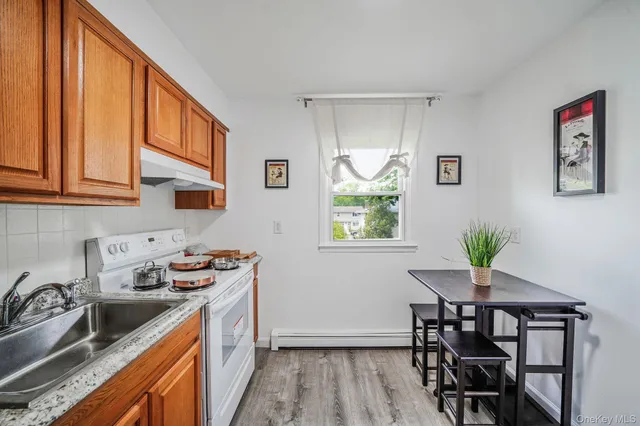 a kitchen with a sink cabinets and wooden floor