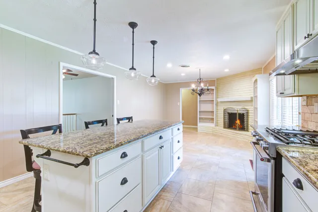 a kitchen with stainless steel appliances granite countertop a stove and a sink