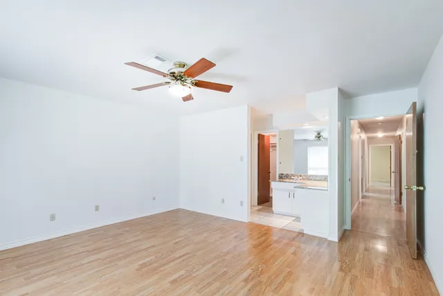 a view of a livingroom with a hardwood floor and a ceiling fan