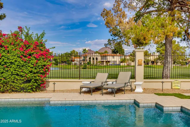 a view of a chair and tables in the patio of the house