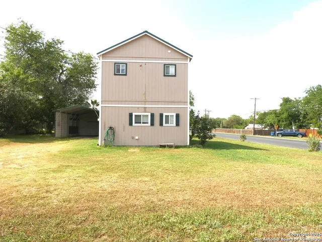 a view of an house with a yard and a garage