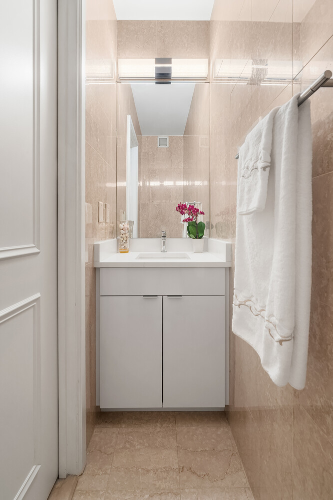 200 East 69th Street, Unit 16E Manhattan, NY 10021 - Photo 11 of 17 a bathroom with a sink and a mirror