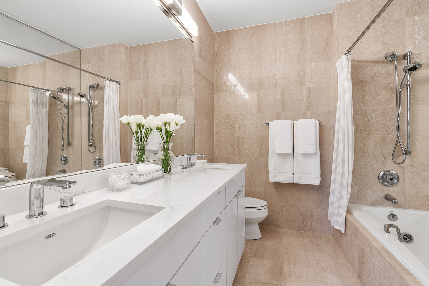 200 East 69th Street, Unit 16E Manhattan, NY 10021 - Photo 15 of 17 a bathroom with a tub sink and mirror