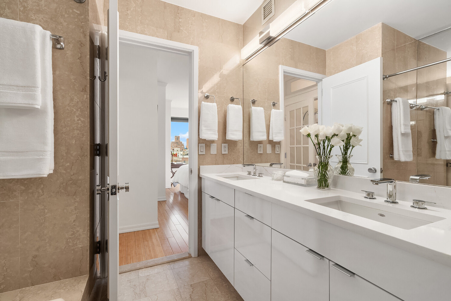 200 East 69th Street, Unit 16E Manhattan, NY 10021 - Photo 16 of 17 a bathroom with a double vanity sink mirror and shower