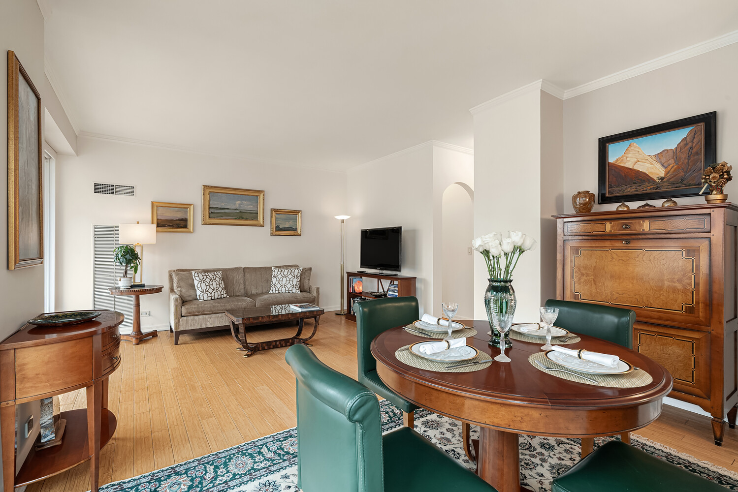 200 East 69th Street, Unit 16E Manhattan, NY 10021 - Photo 2 of 17 a living room with furniture and a flat screen tv