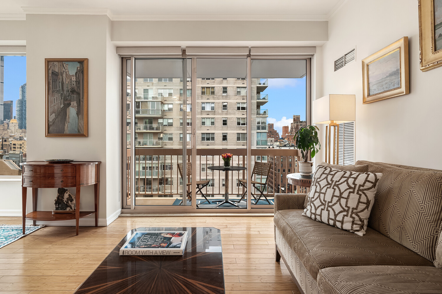 200 East 69th Street, Unit 16E Manhattan, NY 10021 - Photo 4 of 17 a living room with furniture and a large window
