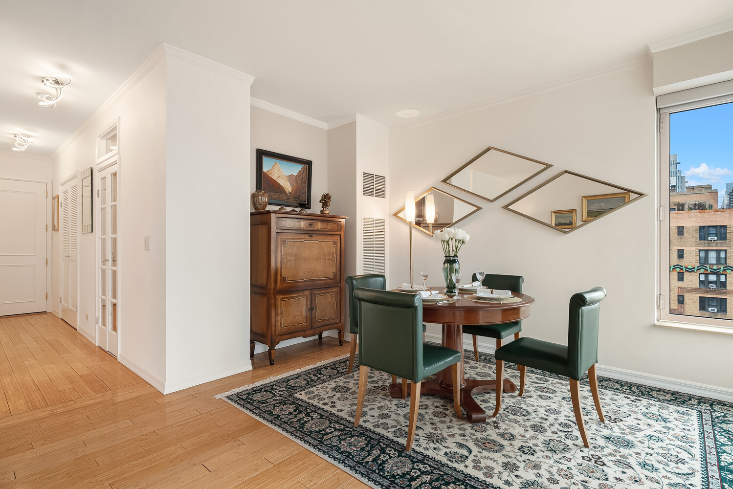 200 East 69th Street, Unit 16E Manhattan, NY 10021 - Photo 6 of 17 a dining room with furniture and a rug