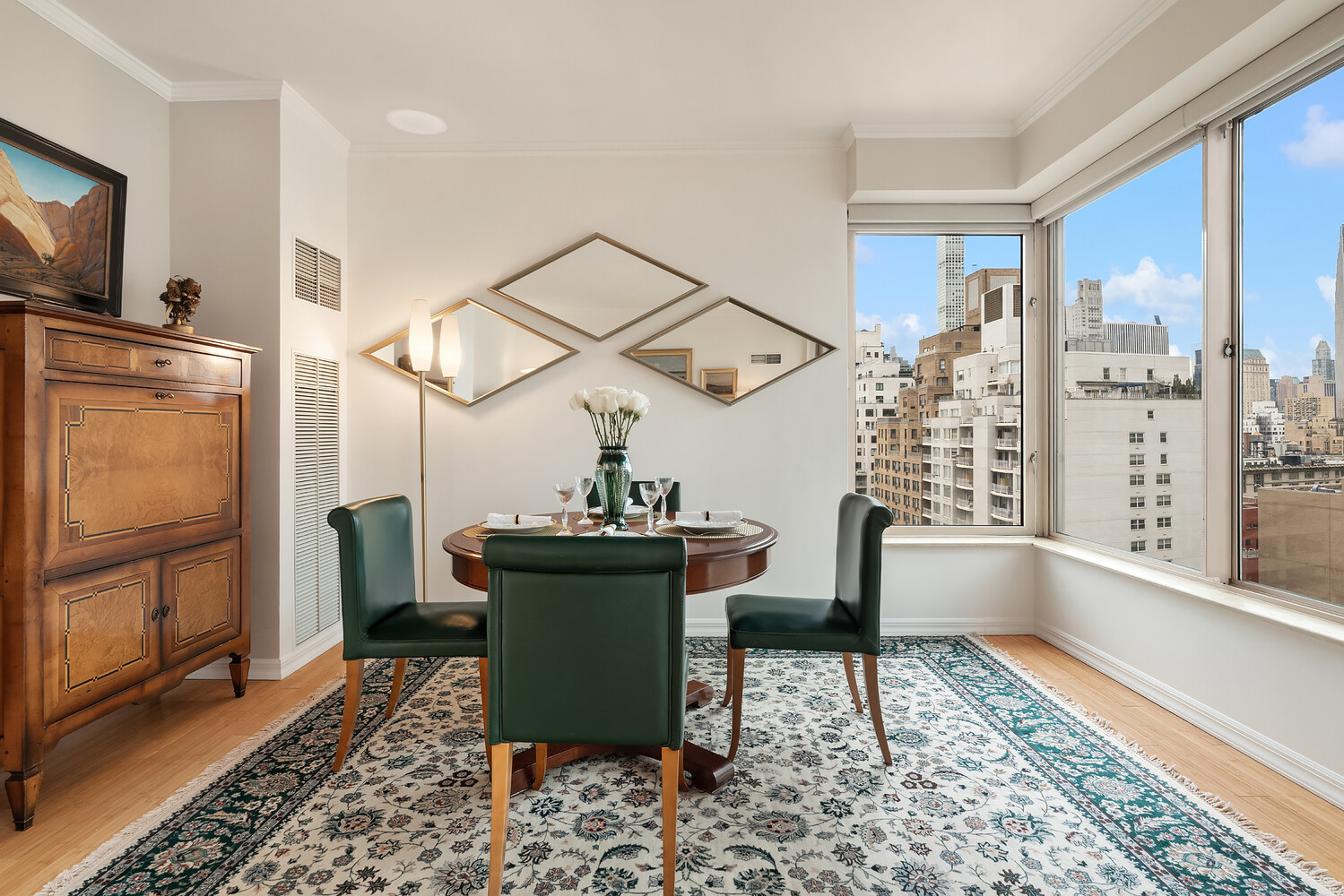 200 East 69th Street, Unit 16E Manhattan, NY 10021 - Photo 7 of 17 a dining room with furniture and a window