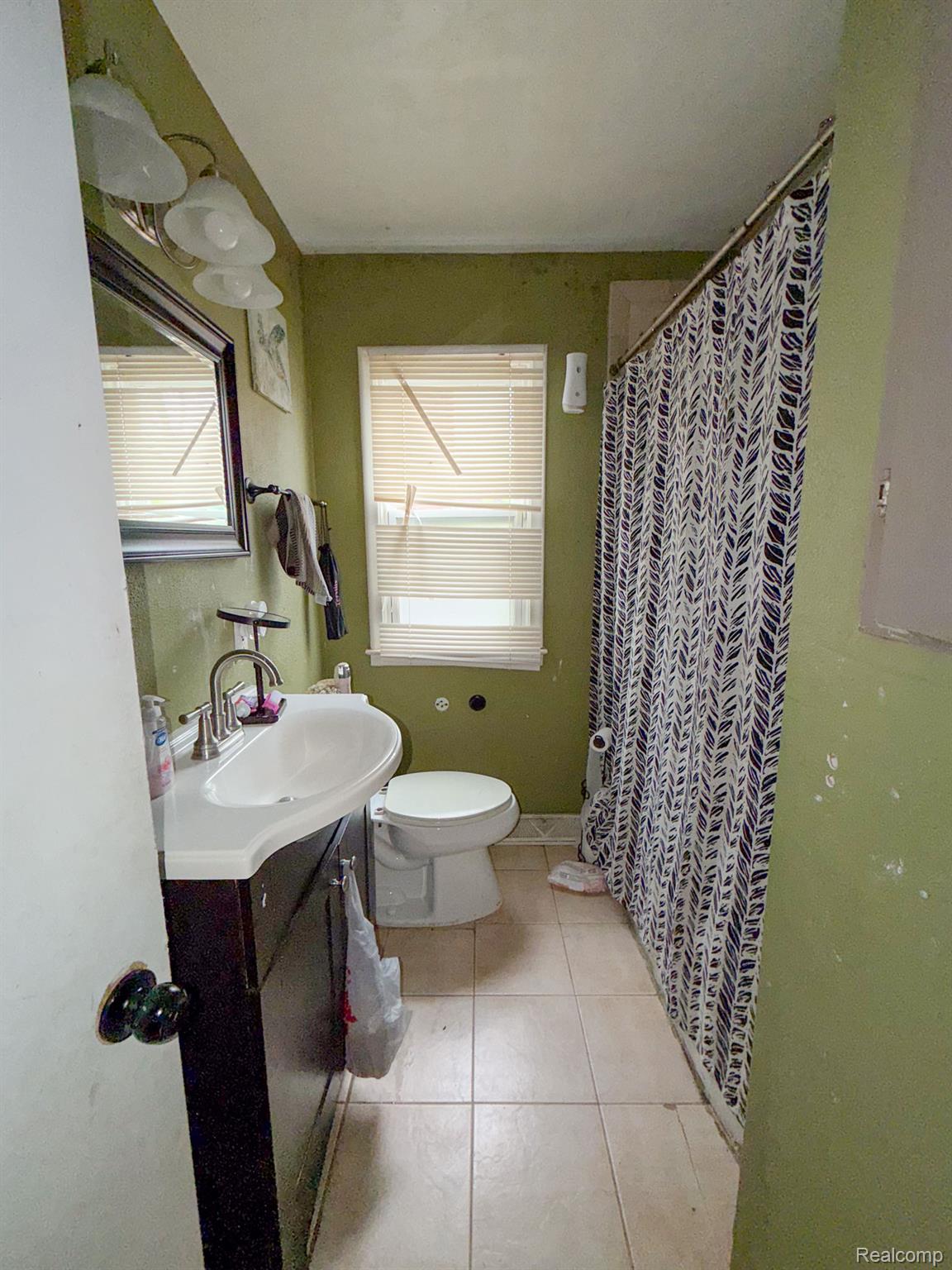 24811 Valley Avenue Eastpointe, MI 48021 - Photo 8 of 22 Full bath with a shower with shower curtain, vanity, and light tile patterned floors