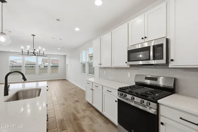 a kitchen with granite countertop a stove and a sink