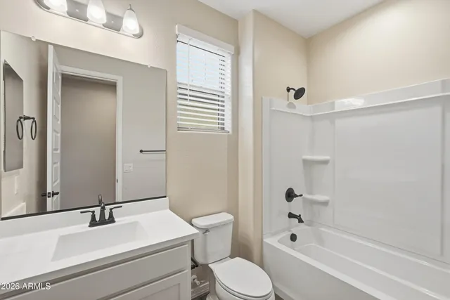 a bathroom with a sink toilet vanity and shower