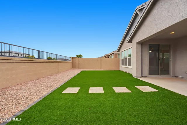 a view of a backyard with plants and lake view