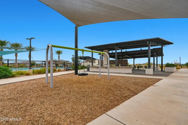 a view of a patio with a table and chairs under an umbrella