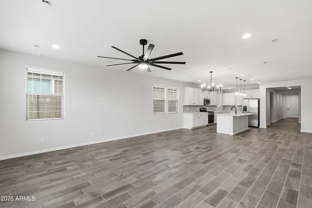 a view of a kitchen with a sink and dishwasher a refrigerator with wooden floor