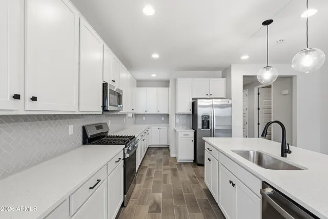 a kitchen with refrigerator cabinets and a sink