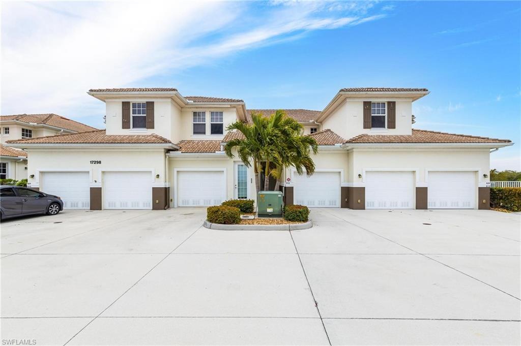 17298 Acapulco Road, Unit 512 Punta Gorda, FL 33955 - Photo 1 of 34 a front view of a house with a yard and garage