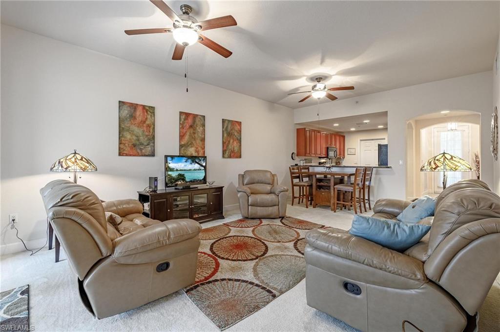 17298 Acapulco Road, Unit 512 Punta Gorda, FL 33955 - Photo 11 of 34 a living room with furniture ceiling fan and a rug