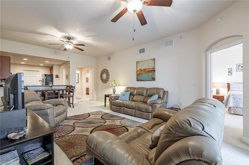 17298 Acapulco Road, Unit 512 Punta Gorda, FL 33955 - Photo 12 of 34 a living room with furniture ceiling fan and a rug